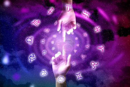Photo for Astrology. People joining fingers, zodiac signs around hands against starry night sky, closeup - Royalty Free Image