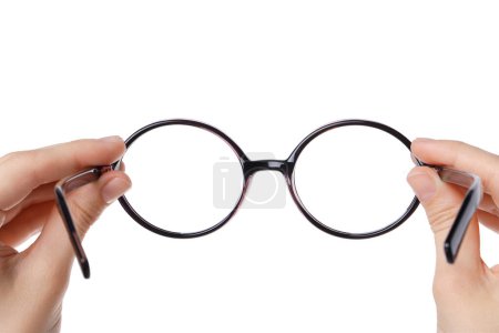 Woman holding stylish glasses with plastic frame on white background, closeup
