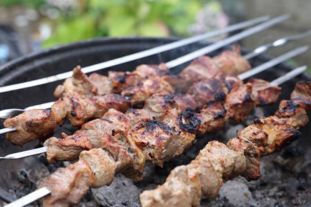 Photo for Cooking delicious kebab on metal brazier outdoors, closeup - Royalty Free Image