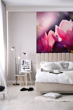 Photo for Stylish bedroom interior with furniture and beautiful floral wallpapers - Royalty Free Image