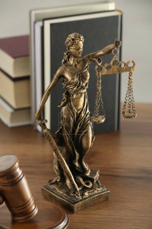 Téléchargez les photos : Figure de Lady Justice, marteau et livres sur table en bois à l'intérieur. Symbole du traitement équitable prévu par la loi - en image libre de droit