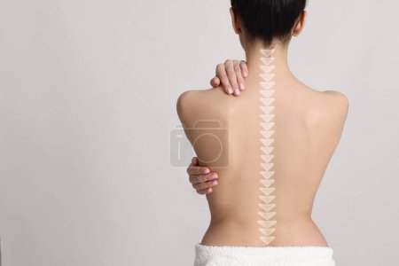 Woman with healthy back on light background, space for text. Illustration of spine