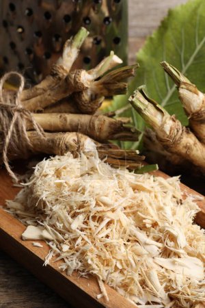 Photo for Grated horseradish and roots on table, closeup - Royalty Free Image