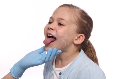 Doctor examining girl`s oral cavity on white background