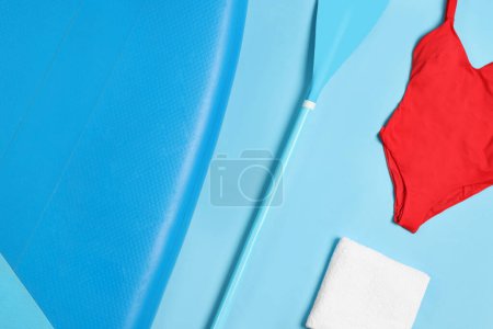 Photo for Flat lay composition with SUP board on light blue background. Water sport - Royalty Free Image