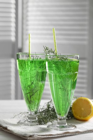 Photo for Glasses of homemade refreshing tarragon drink on table - Royalty Free Image