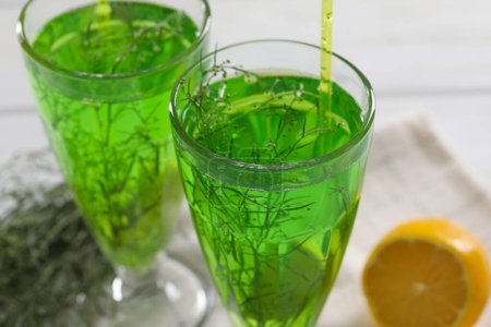 Photo for Glasses of homemade refreshing tarragon drink on table, closeup - Royalty Free Image