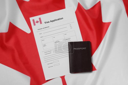 Immigration to Canada. Visa application form and passport on flag, flat lay