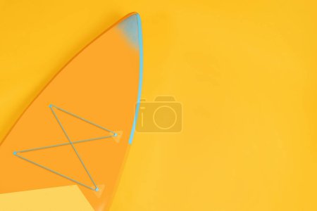 Photo for One SUP board on orange background, top view with space for text. Water sport - Royalty Free Image