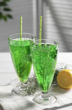 Photo for Glasses of homemade refreshing tarragon drink on table - Royalty Free Image