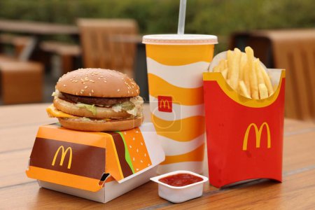 Photo for Lviv, Ukraine - October 9, 2023: McDonald's menu on wooden table outdoors - Royalty Free Image