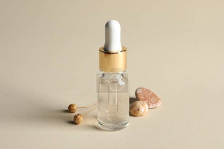 Photo for Composition with bottle of cosmetic serum on beige background - Royalty Free Image