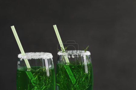 Photo for Glasses of homemade refreshing tarragon drink on black background - Royalty Free Image