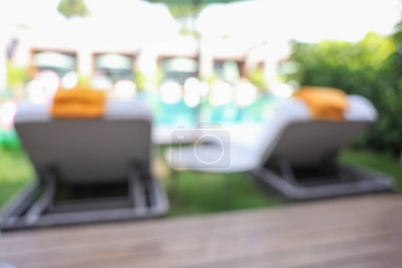 Photo for Sunbeds near swimming pool at luxury resort, blurred view - Royalty Free Image