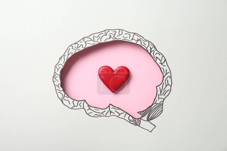 Photo for Emotional thinking. Red heart on pink background, top view through paper with brain shaped hole and drawing - Royalty Free Image