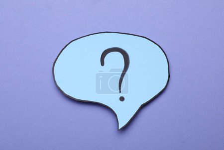Photo for Paper speech bubble with question mark on violet background, top view - Royalty Free Image