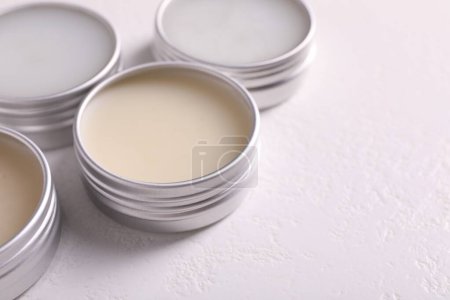 Photo for Different lip balms on white table, closeup. Space for text - Royalty Free Image