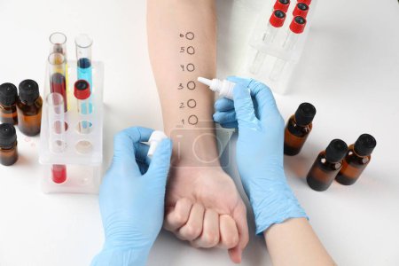 Photo for Doctor doing skin allergy test at light table, above view - Royalty Free Image