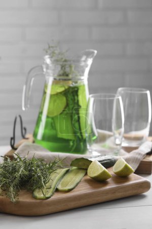 Photo for Fresh homemade refreshing tarragon drink and ingredients on white wooden table - Royalty Free Image