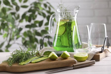 Photo for Fresh homemade refreshing tarragon drink, knife and ingredients on white wooden table, space for text - Royalty Free Image