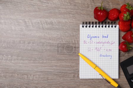 Photo for Notebook with calculated glycemic load for strawberry and fresh berries on wooden table, flat lay. Space for text - Royalty Free Image