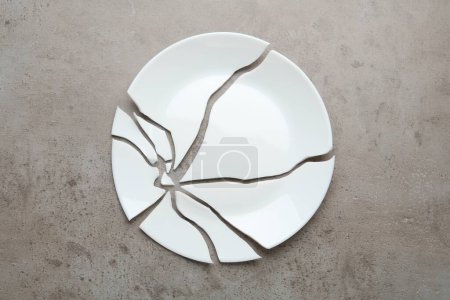 Photo for Pieces of broken ceramic plate on grey table, flat lay - Royalty Free Image
