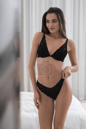 Photo for Young woman in elegant black underwear indoors - Royalty Free Image