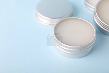 Photo for Lip balms on light blue background, closeup. Space for text - Royalty Free Image