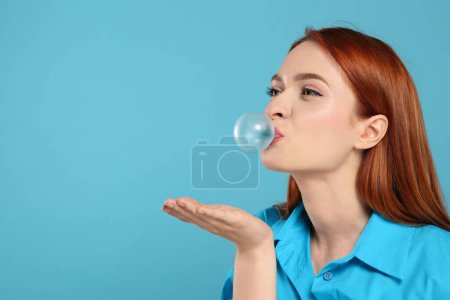 Photo for Beautiful woman blowing bubble gum on turquoise background, space for text - Royalty Free Image