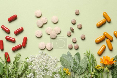 Photo for Different pills, herbs and flowers on light green background, flat lay. Dietary supplements - Royalty Free Image