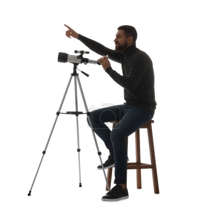 Happy astronomer with telescope pointing at something on white background