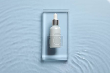 Photo for Bottle of cosmetic serum and water on light blue background, top view - Royalty Free Image