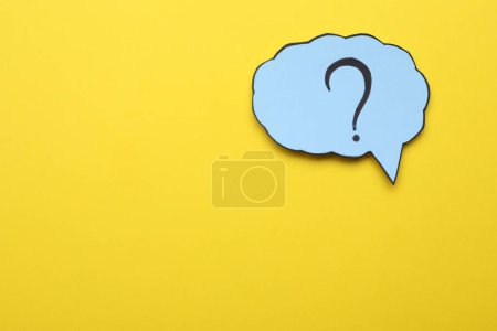 Photo for Paper speech bubble with question mark on yellow background, top view. Space for text - Royalty Free Image
