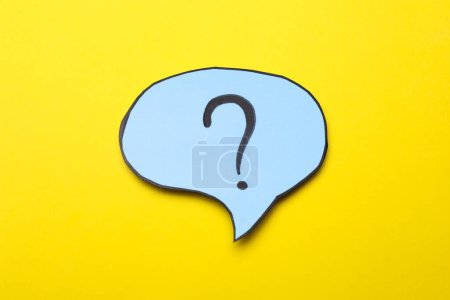 Photo for Paper speech bubble with question mark on yellow background, top view - Royalty Free Image