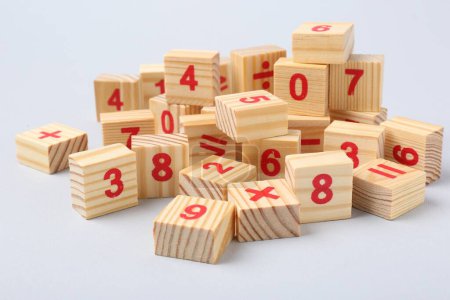 Photo for Wooden cubes with numbers and mathematical symbols on light background - Royalty Free Image