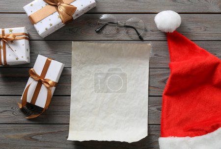 Photo for Flat lay composition with blank paper sheet and Christmas decor on wooden table, space for text. Letter for Santa - Royalty Free Image