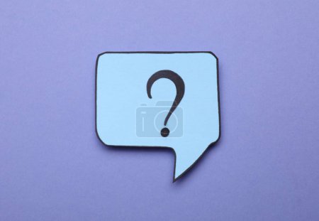 Photo for Paper speech bubble with question mark on violet background, top view - Royalty Free Image