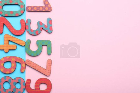 Photo for Wooden numbers on colorful background, flat lay. Space for text - Royalty Free Image