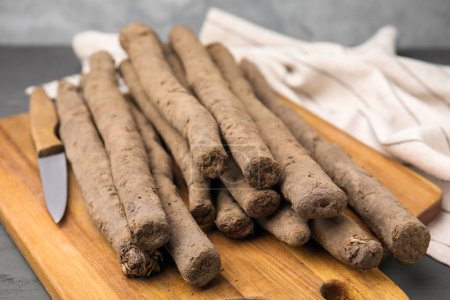 Photo for Raw salsify roots on grey table, closeup - Royalty Free Image