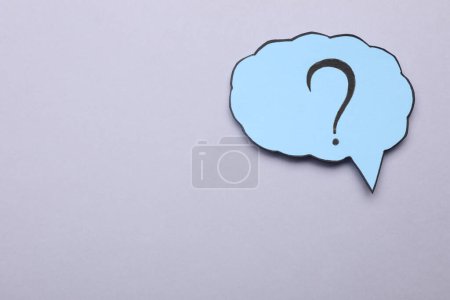 Photo for Paper speech bubble with question mark on light grey background, top view. Space for text - Royalty Free Image