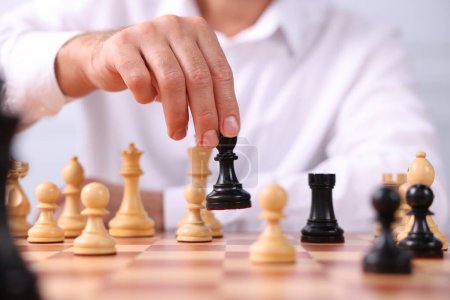 Homme en mouvement pièce d'échecs au damier, gros plan