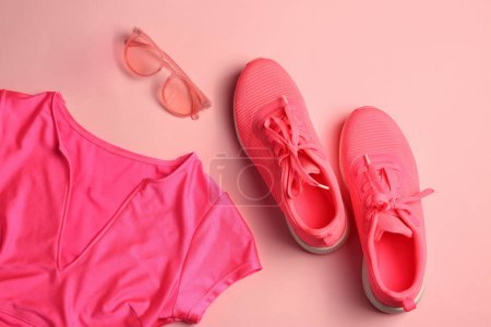 Stylish sunglasses, antiperspirant, pink sneakers and t-shirt on color background, flat lay