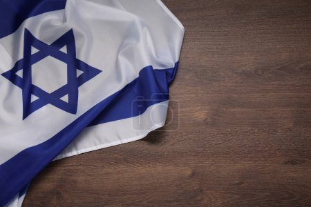 Flag of Israel on wooden background, top view and space for text. National symbol