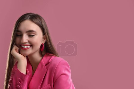 Beautiful woman in pink clothes on color background, space for text