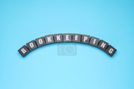 Word Bookkeeping made with black cubes on light blue background, top view