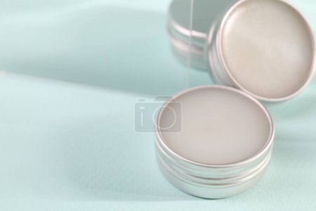 Photo for Lip balms on light blue background, space for text - Royalty Free Image