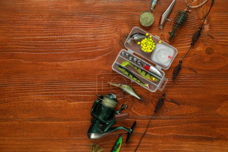 Photo for Fishing tackle on wooden table, flat lay. Space for text - Royalty Free Image