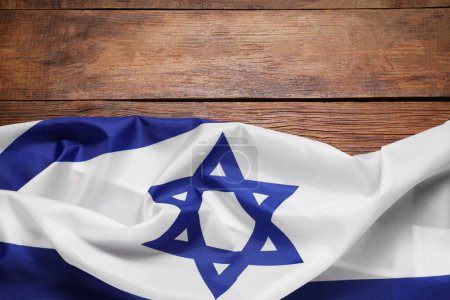 Flag of Israel on wooden background, top view and space for text. National symbol