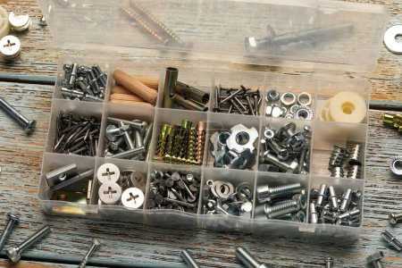 Photo for Organizer with many different fasteners on rustic wooden table, above view - Royalty Free Image