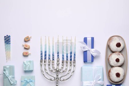 Photo for Flat lay composition with Hanukkah menorah and gift boxes on light background. Space for text - Royalty Free Image